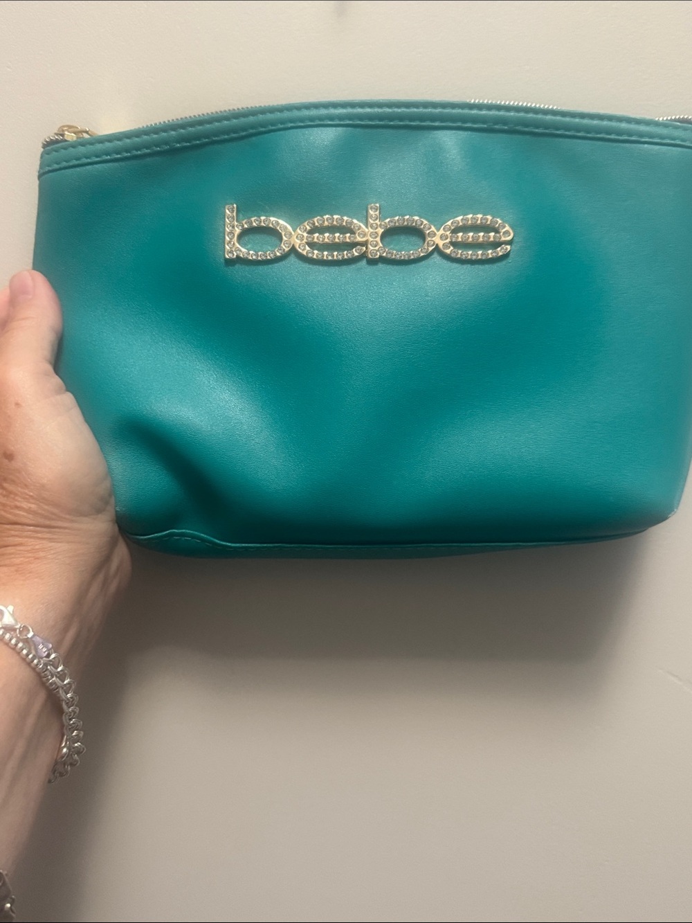 bebe Teal Cosmetic Pouch with Crystal Logo- see photos some wear. Sold as is.